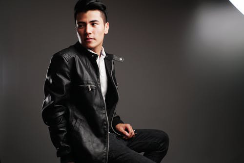 A man wearing a zip leather jacket