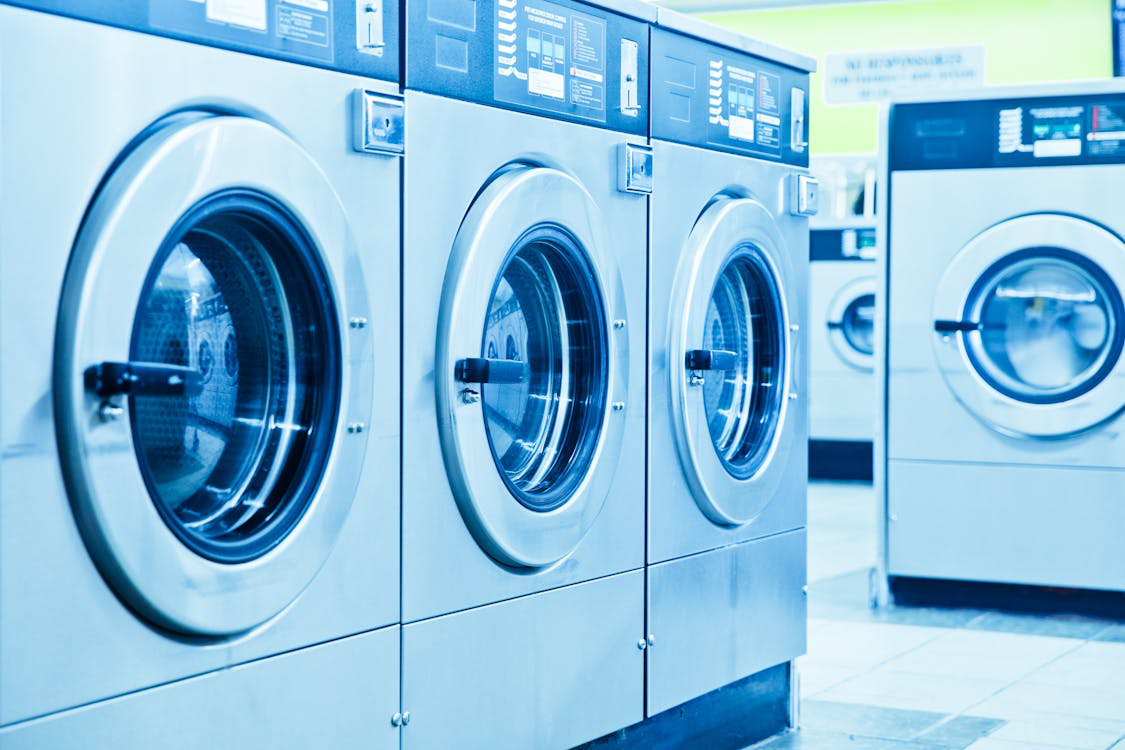 An image of washing machines in a professional dry cleaning company