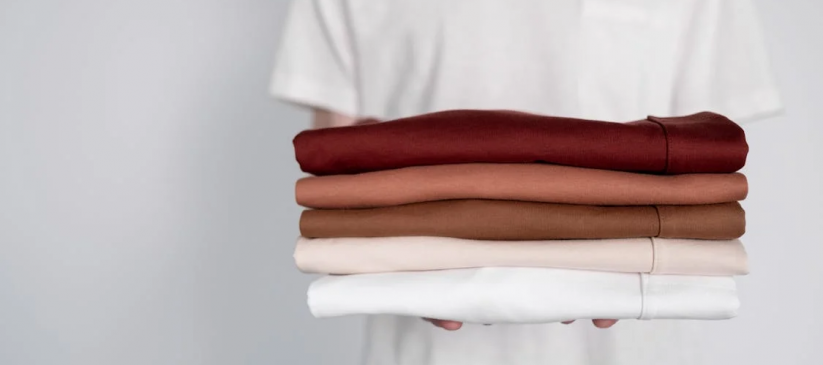 A person holding freshly laundered white hotel linens