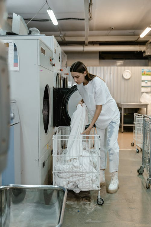 A professional laundry service worker handling restaurant linens