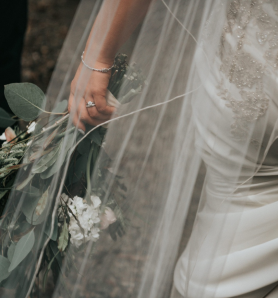 person in a wedding dress holding flowers