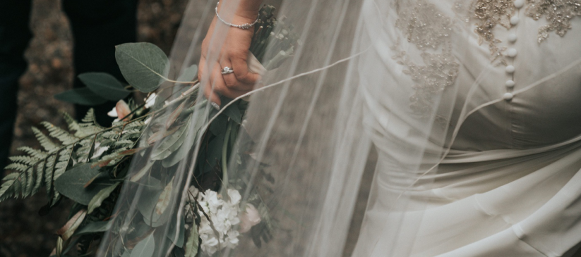 person in a wedding dress holding flowers