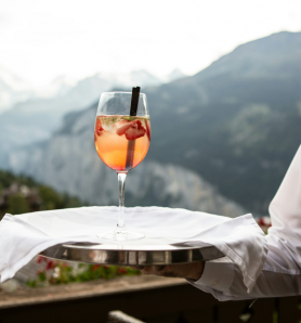 waiter carrying a drink in a tray