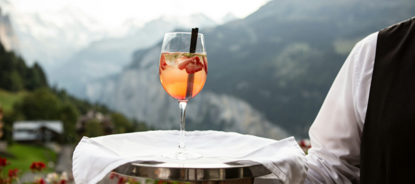 waiter carrying a drink in a tray